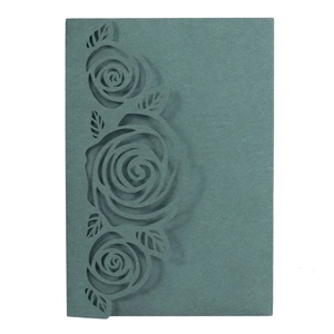 Detail of laser-cut rose floral pattern on Morandi green wedding invitation card