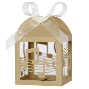 Macro view of champagne gold musical note favor box with laser-cut stave patterns
