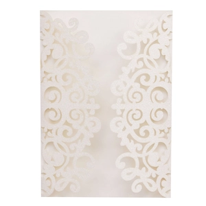 Intricate laser-cut wedding invitation with white glitter texture and baroque floral patterns