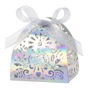 Iridescent laser-cut favor box with heart vine patterns and a blue ribbon bow tie