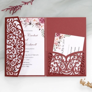 Elegant burgundy laser-cut floral wedding invitation set with RSVP card on lace background