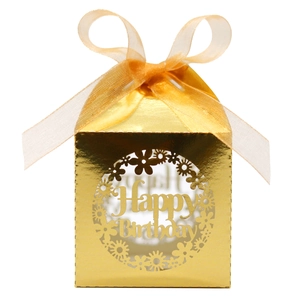 Detail of laser-cut gold Happy Birthday favor box with floral wreath and ribbon