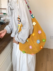 Handmade crochet tote bag with colorful 3D floral accents and hollow knit design