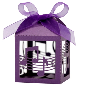 Laser-cut purple musical note candy box with sheet music patterns and ribbon bow