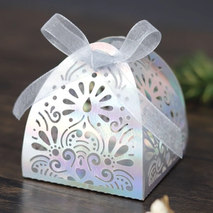Close-up of laser-cut floral pattern on iridescent silver wedding favor gift box