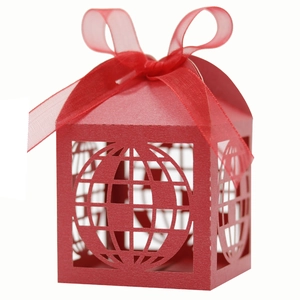 Detail of red laser-cut candy box with globe pattern and matching chiffon ribbon bow