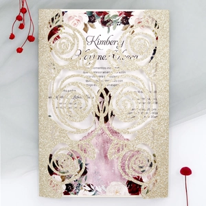 Detail of laser-cut gold glitter rose invitation card with purple floral inner sheet