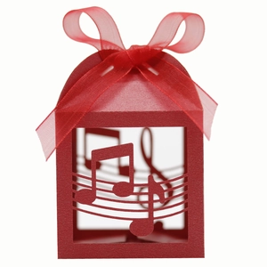 Detail of red hollowed music note candy box with elegant laser cut staff and satin ribbon