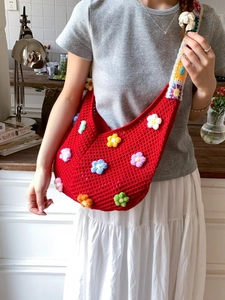Handmade hollow knit tote bag with 3D floral accents and colorful checkered shoulder strap