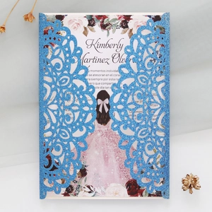 Detail view of laser-cut glitter blue invitation with elegant floral girl illustration