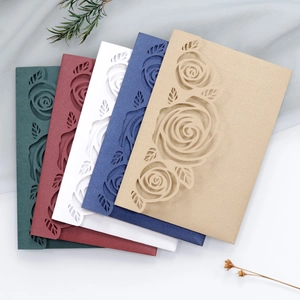 Macro detail of laser-cut rose patterns on elegant pearlescent invitation cards set