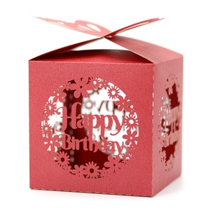 Detail of red laser-cut candy box featuring hollowed Happy Birthday and 3D butterfly