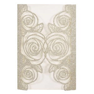 Detail of laser-cut rose floral pattern on champagne gold glitter wedding invitation card