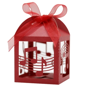 Close-up of red laser-cut music note gift box with elegant ribbon bow detail