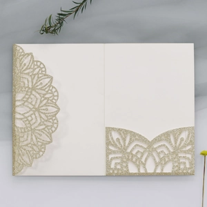 Detailed laser-cut glitter wedding invitation with intricate mandala patterns on beige card