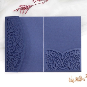 Macro view of navy blue laser-cut wedding invitation pocket with intricate hollowed patterns