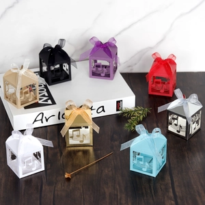 Detail of laser-cut musical notes on colorful party favor boxes with ribbon bows