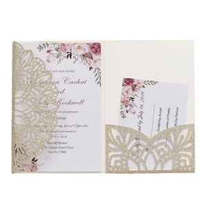 Detail of laser cut glitter gold wedding invitation with floral watercolor card and RSVP