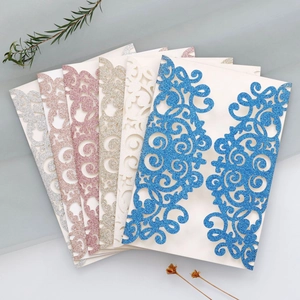 Detailed view of laser-cut glitter paper invitations in diverse elegant colors