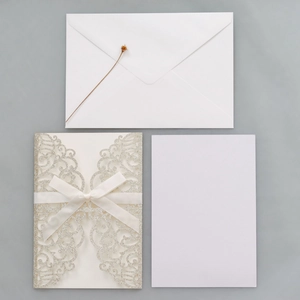 Laser-cut silver glitter wedding invitation set with silk bow and white inserts