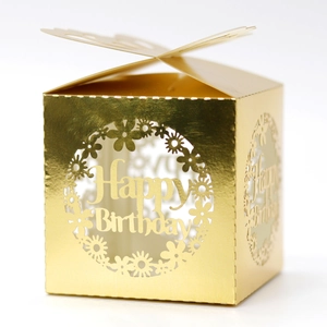 Macro detail of golden laser-cut butterfly gift box with Happy Birthday镂空 design