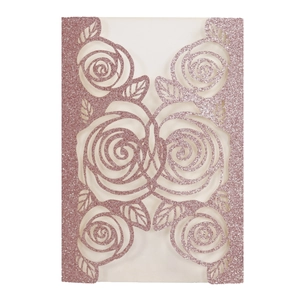 Intricate laser-cut rose patterns on pink glitter paper wedding invitation card detail