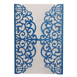 Intricate laser cut blue glitter invitation card cover with symmetrical vine patterns