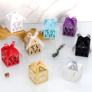 Detail of laser-cut party gift boxes with musical notes and ribbon bows in eight colors