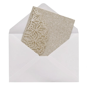Detail of laser-cut wedding invitation with champagne gold glitter floral texture