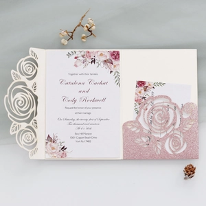Detailed laser-cut rose wedding invitation set with glitter pink insert and watercolor card