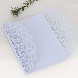 Detailed laser-cut lavender pearl paper invitation cover with elegant floral patterns
