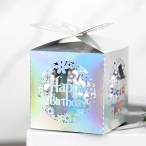 Macro view of holographic laser-cut Happy Birthday candy box with butterfly closure