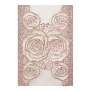 Close-up of laser-cut rose gold glitter invitation cover with intricate floral rose patterns