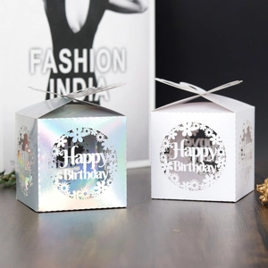 Detail view of laser-cut Happy Birthday candy boxes in white and holographic finish