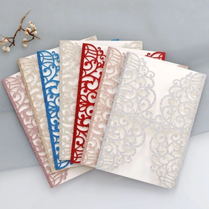 Close-up of glitter hollow laser cut invitation cards in seven assorted elegant colors