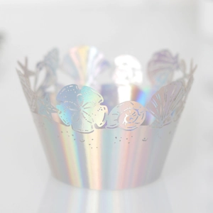 Close-up of laser-cut iridescent ocean theme cupcake wrappers with sea shells