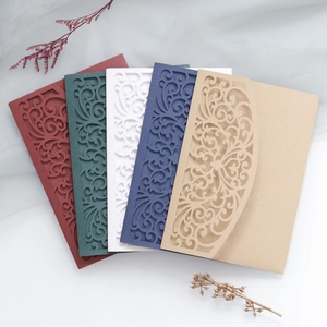 Detail view of laser cut wedding invitation cards with ornate European hollow patterns