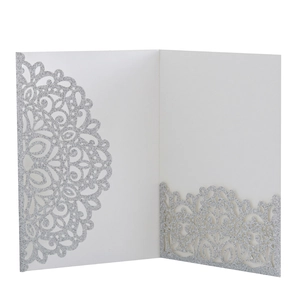 Detailed laser-cut mandala floral patterns on white and silver glitter wedding invitation