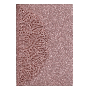 Macro detail of rose gold glitter wedding invitation with laser-cut mandala pattern
