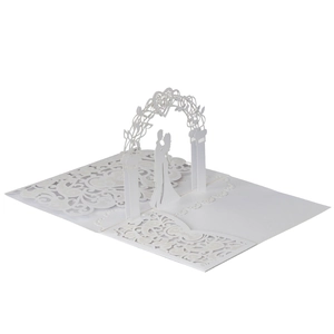 Macro detail of intricate laser-cut 3D pop-up wedding invitation with elegant silhouette