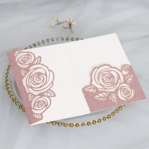 Detailed laser-cut pink glitter rose invitation card with elegant cream-colored insert paper