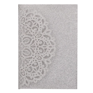 Detailed macro view of laser-cut silver glitter wedding invitation with mandala pattern