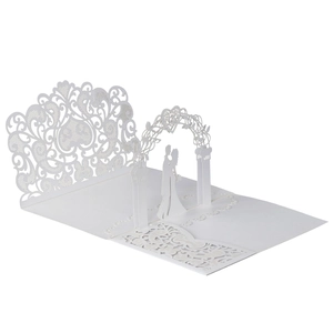 Detail of 3D laser-cut wedding invitation showing intricate floral patterns and couple silhouette