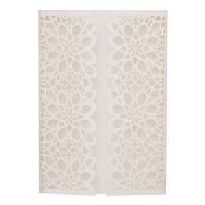 Detail of laser-cut floral pattern on white glittery paper wedding invitation cover