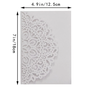 Close-up of laser-cut white card with floral lace patterns, 5x7 inch invitation detail