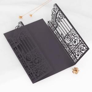 Elegant black laser-cut wedding invitation gatefold with intricate floral patterns