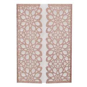 Macro detail of rose gold glitter laser cut invitation cover with hollow floral patterns
