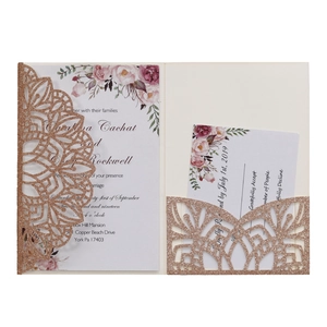 Detail of laser cut glitter wedding invitation with pink floral RSVP cards