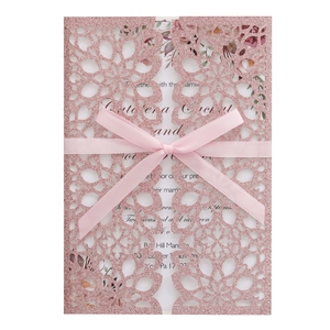 Rose gold glitter laser cut wedding invitation with elegant floral lace and pink bow