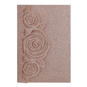 Detail of rose gold glitter card featuring laser-cut floral rose embossed textures
